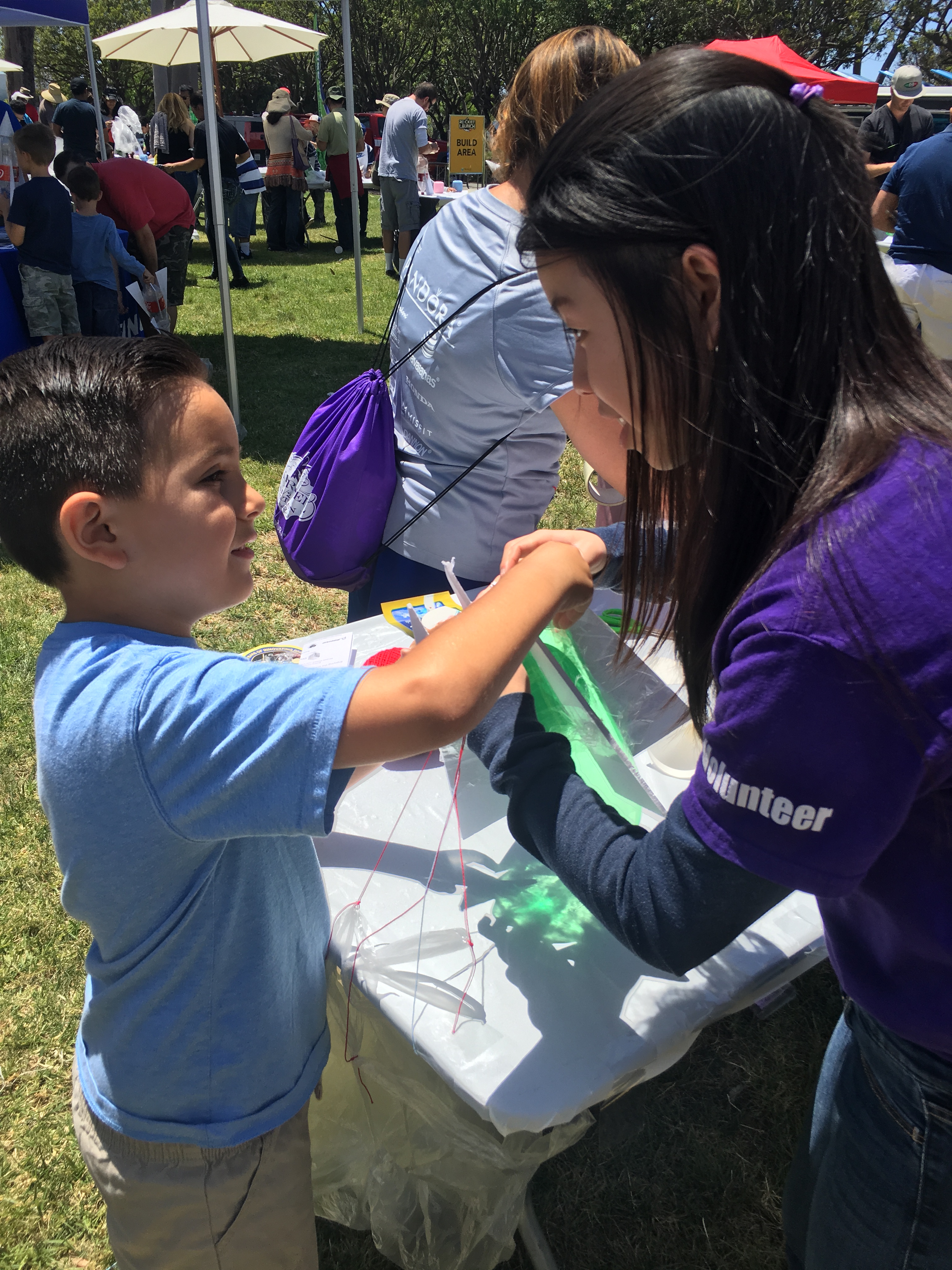 Noah and volunteer constructing his rocket